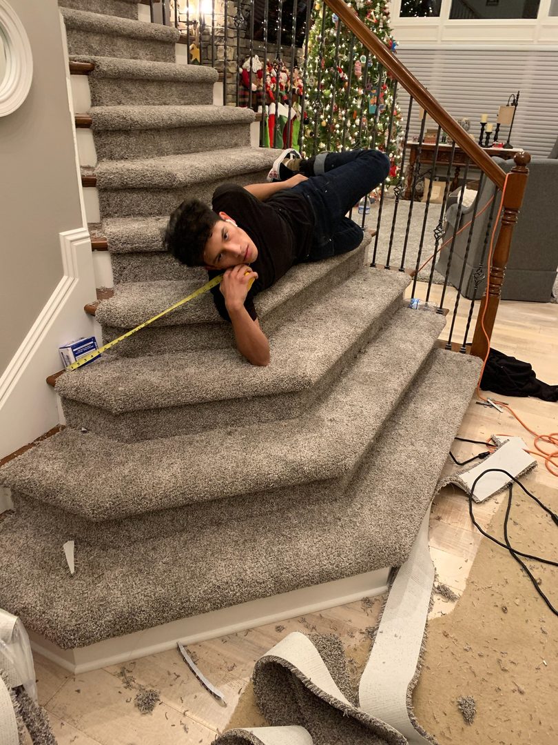 Z Flooring owner Irvin Diaz installing a carpet stair runner in Hamilton County, Indiana